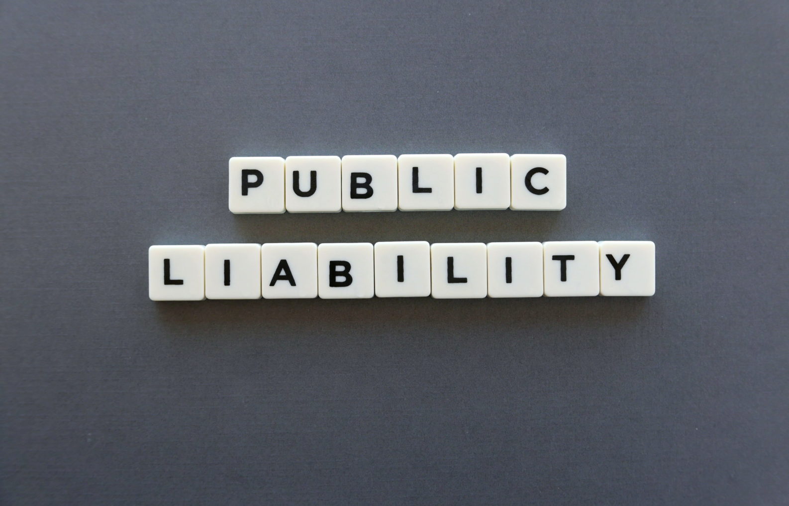 Public liability word made of square letter word on grey background.