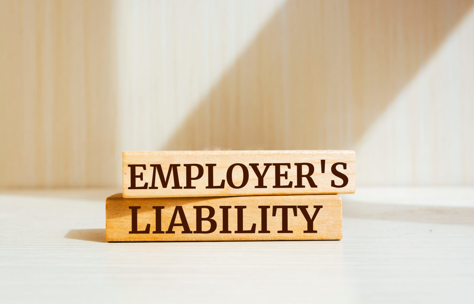 Wooden blocks with words 'EMPLOYER'S LIABILITY'. Business concep